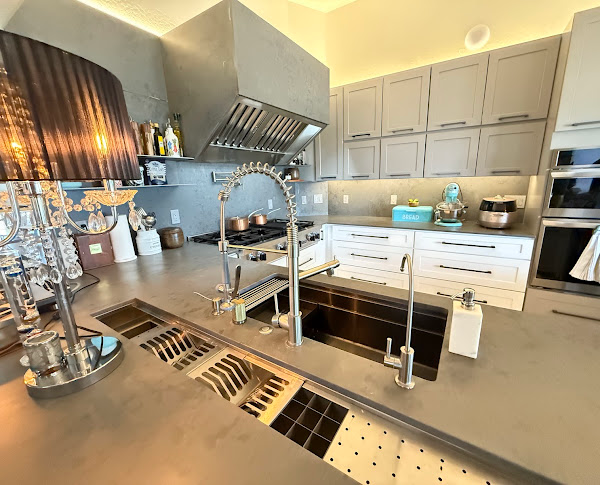 Kitchen remodel featuring quartz countertops, cabinets, backsplash tile and modern lighting in Prescott, AZ